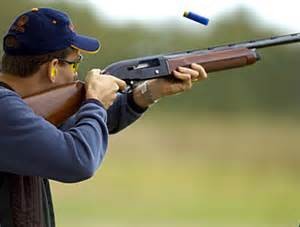 man shooting clay pigeons with shotgun at Poetry Shooting Club