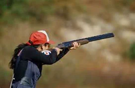 Woman shooting a clay pigeon at a Dallas Private Shooting Range